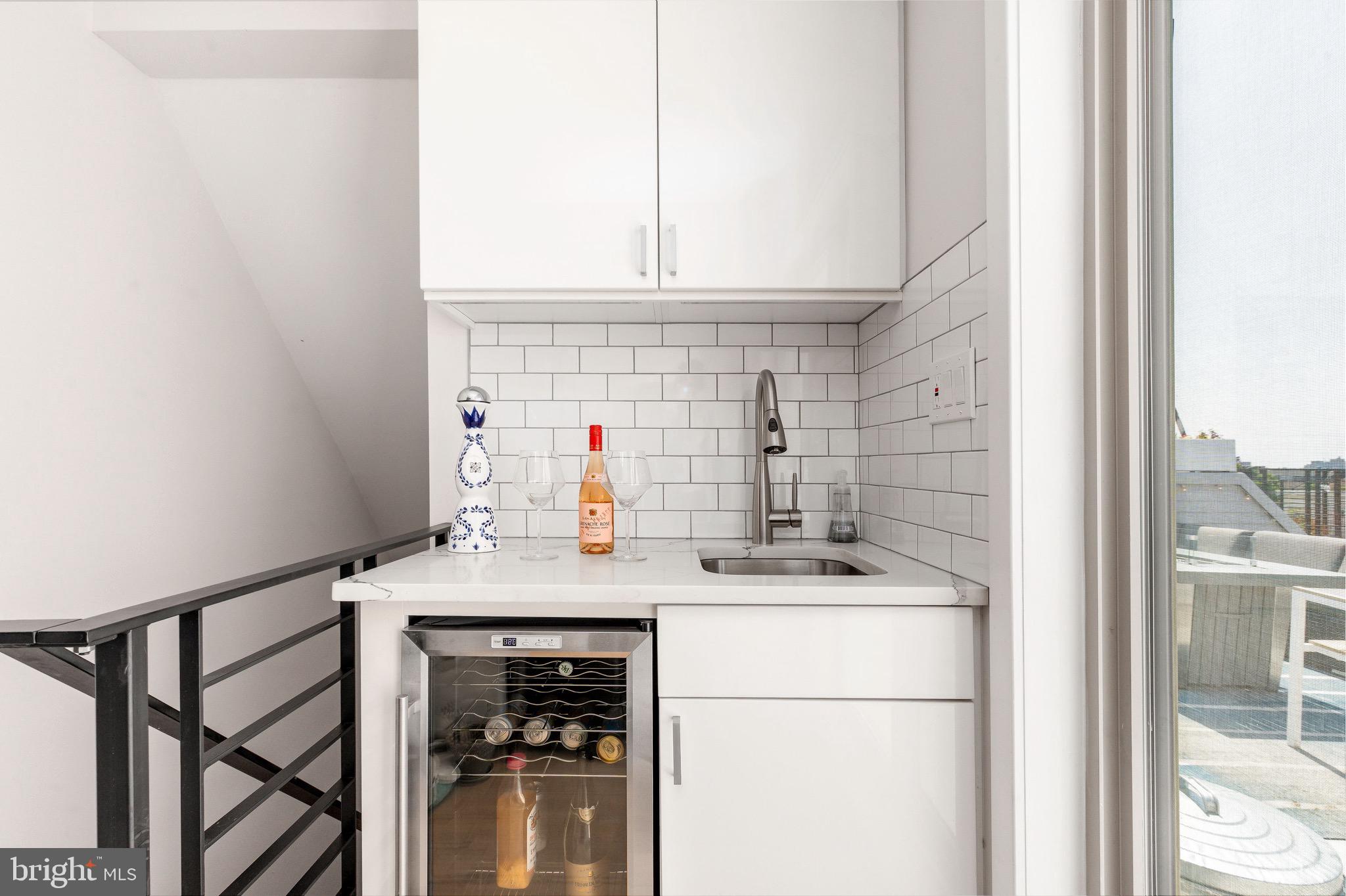 1733 Carpenter Street, Unit D Philadelphia, PA 19146 - Photo 31 of 37 a kitchen with a sink cabinets and a refrigerator