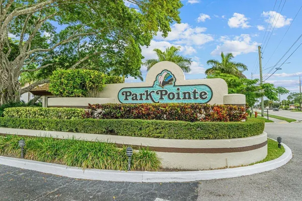 a view of sign board and a yard