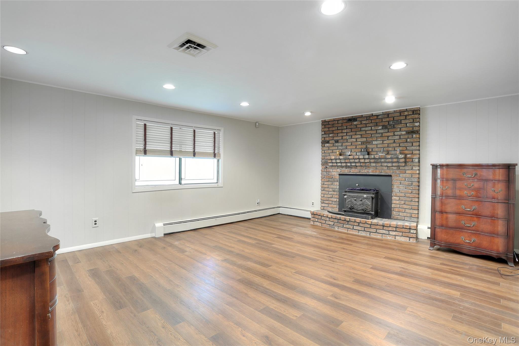 47 Camp Hill Road Pomona, NY 10970 - Photo 20 of 30 an empty room with wooden floor and fireplace
