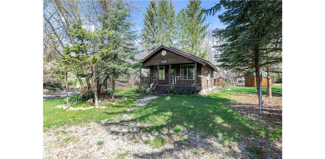 1105 Litz Road Preston, ID 83263 - Photo 15 of 24 View of front of house featuring covered porch and a front lawn