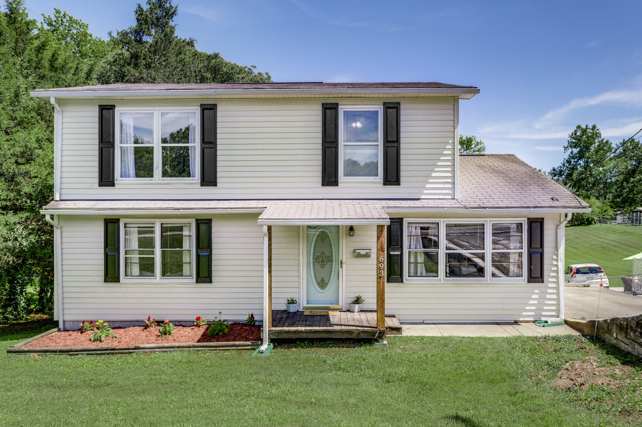 693 Robertsville Road Oak Ridge, TN 37830 - Photo 1 of 22 a front view of a house with a garden