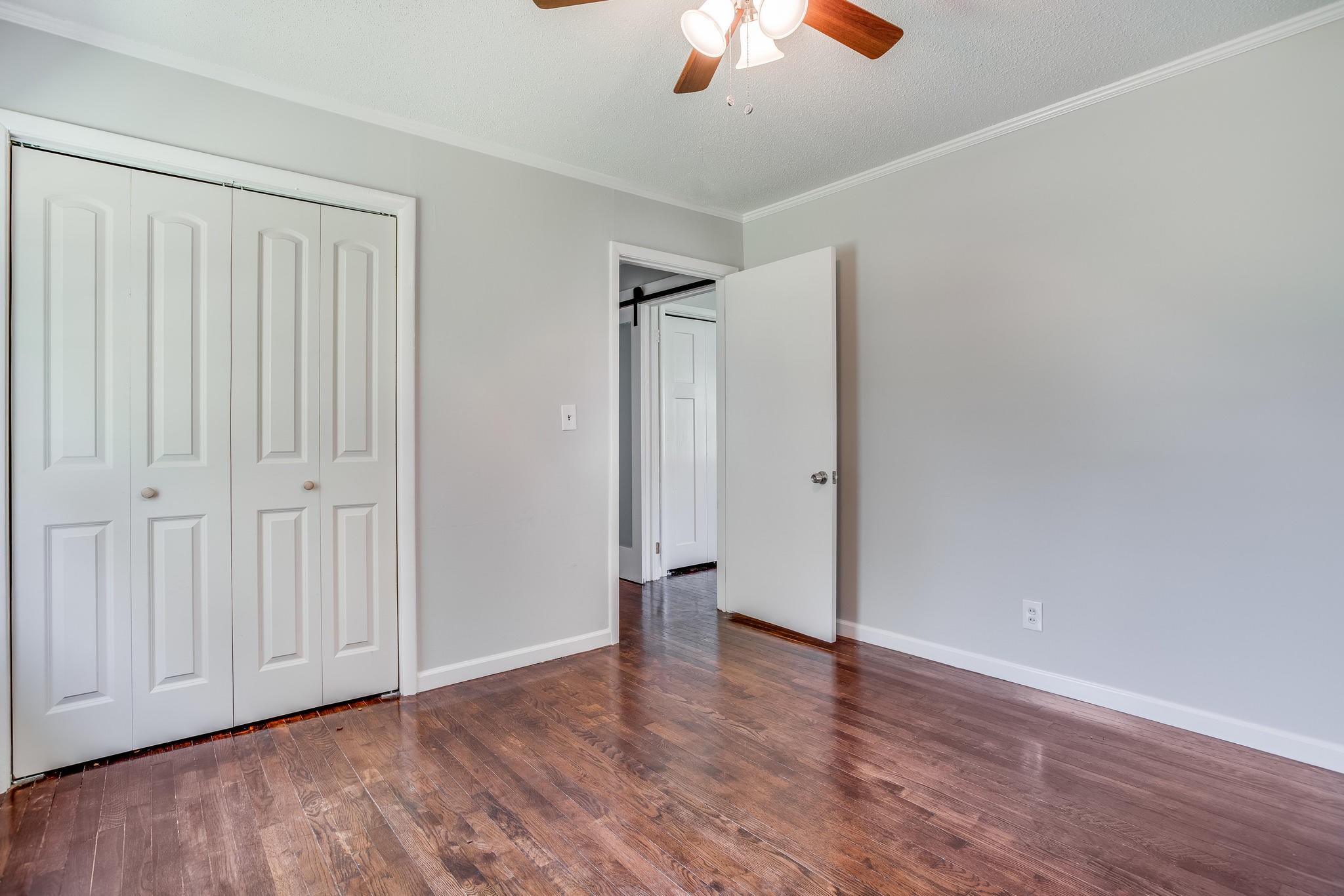 693 Robertsville Road Oak Ridge, TN 37830 - Photo 17 of 22 an empty room with wooden floor ceiling fan