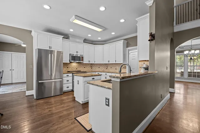 a kitchen with a refrigerator sink and cabinets