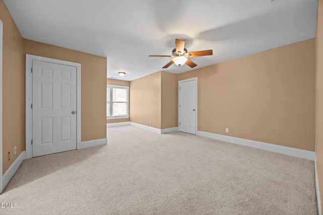 a view of empty room with ceiling fan