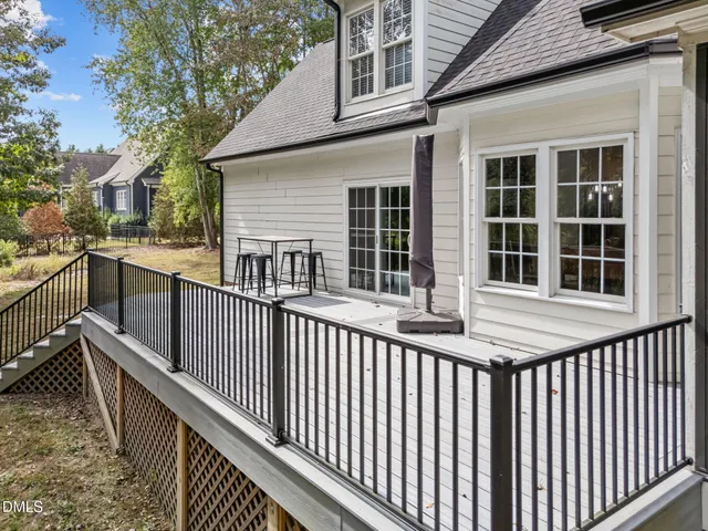a view of a house with a wooden fence