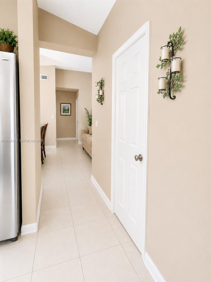 14856 Southwest 179th Street Miami, FL 33187 - Photo 27 of 33 a view of a hallway with wooden floor and a potted plant