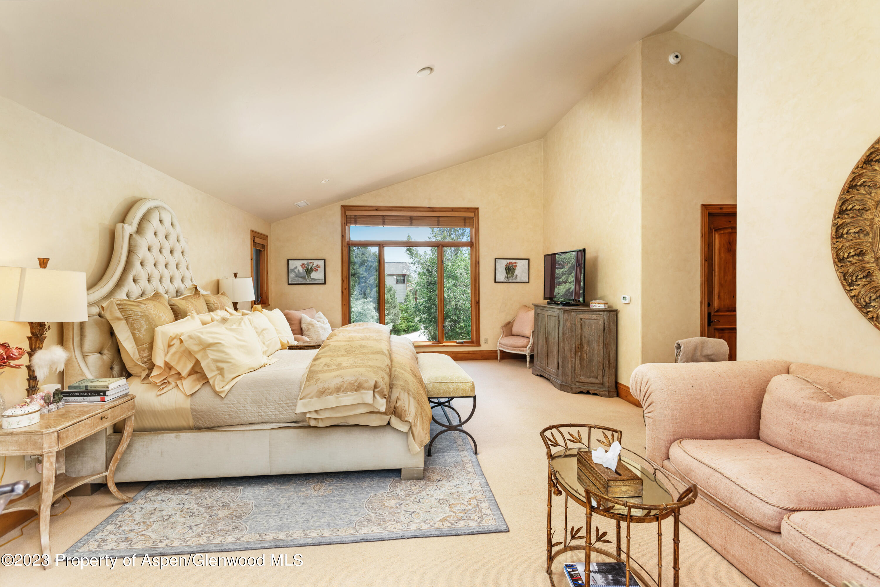 121 Ridge Road Basalt, CO 81621 - Photo 12 of 25 a spacious bedroom with a bed a couch and large windows