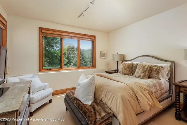a bedroom with a bed and glass window