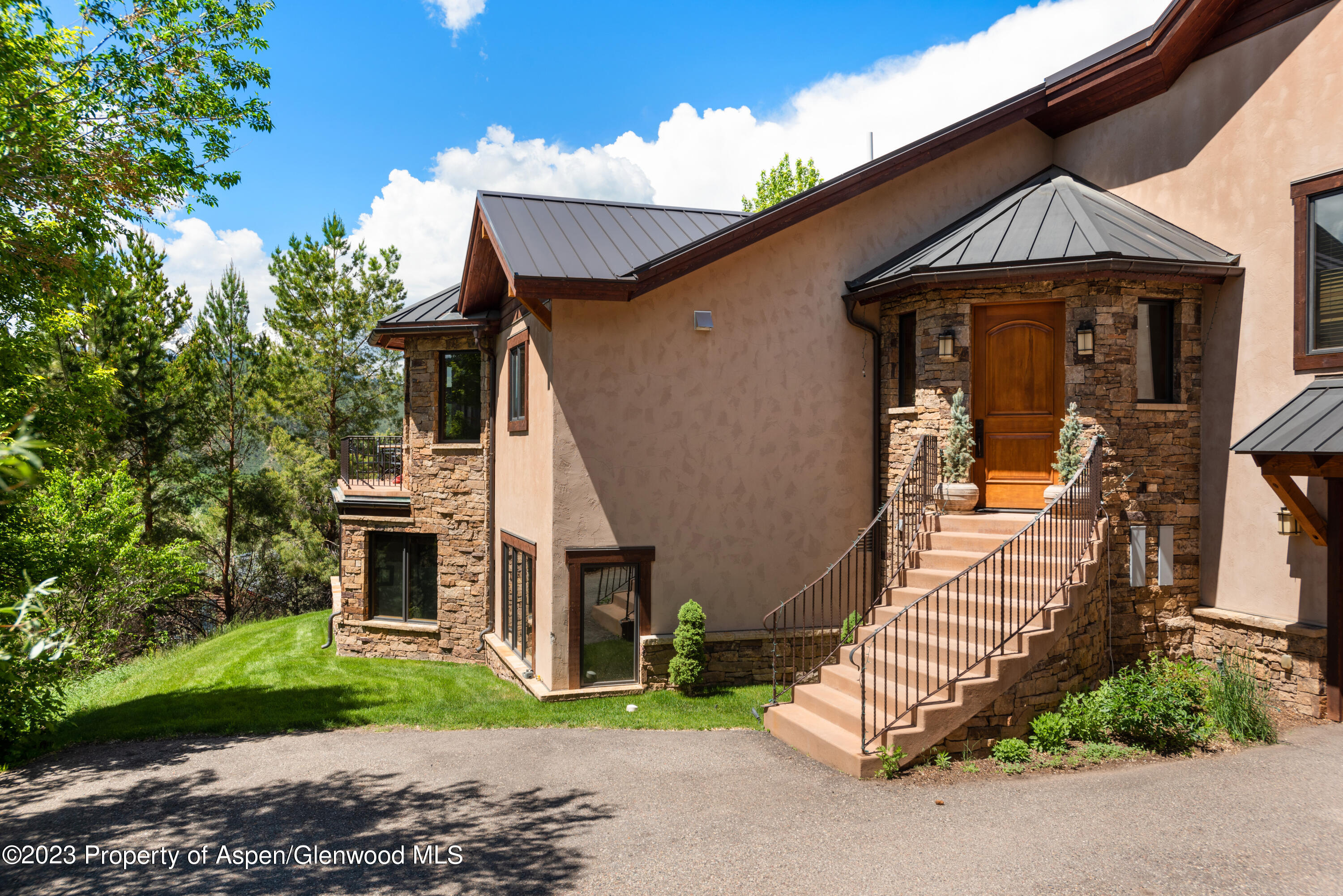 121 Ridge Road Basalt, CO 81621 - Photo 3 of 25 a front view of a house with a garden