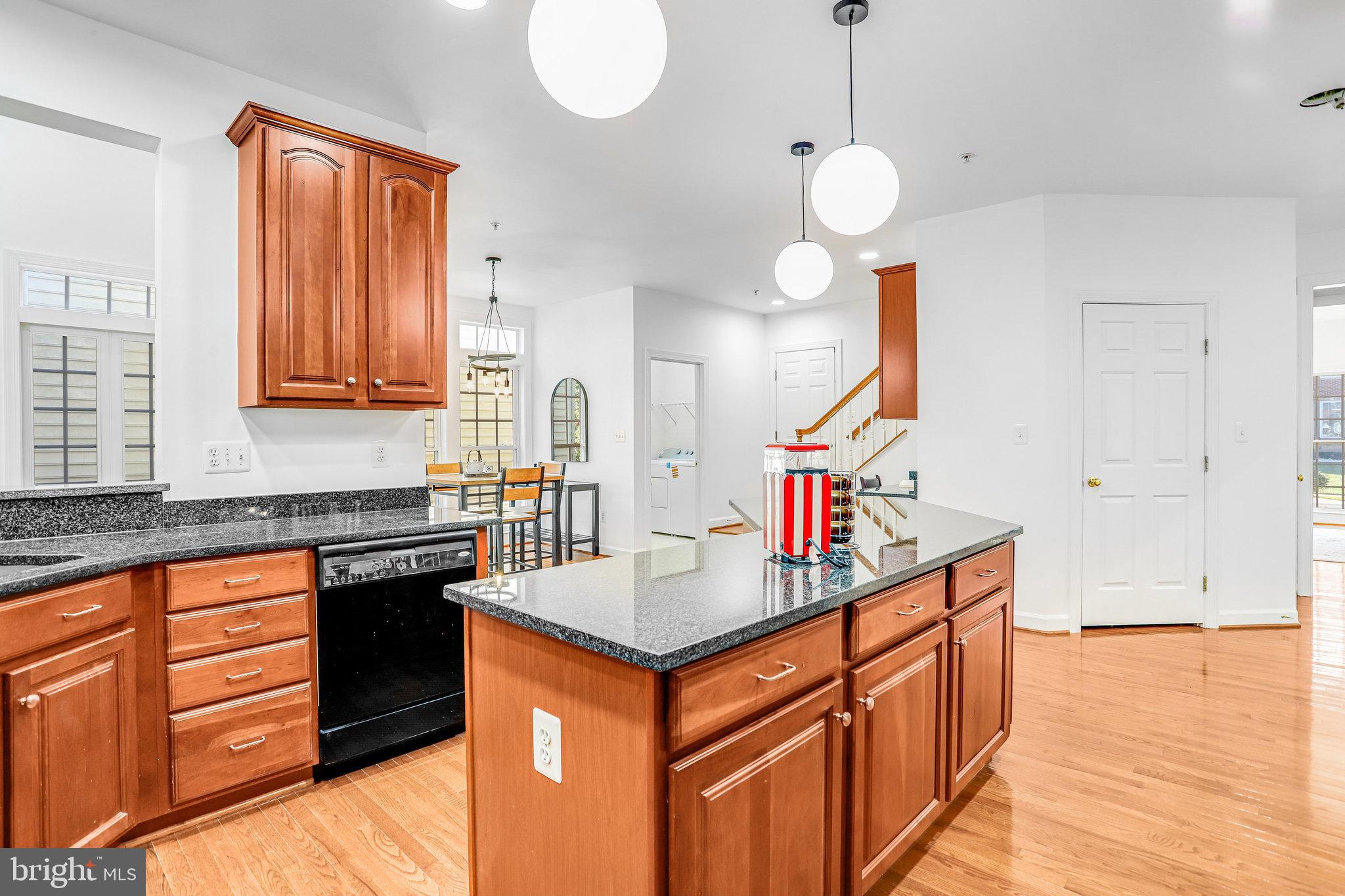 13107 English Turn Drive Silver Spring, MD 20904 - Photo 29 of 73 a kitchen that has cabinets a sink a stove and a wooden floors