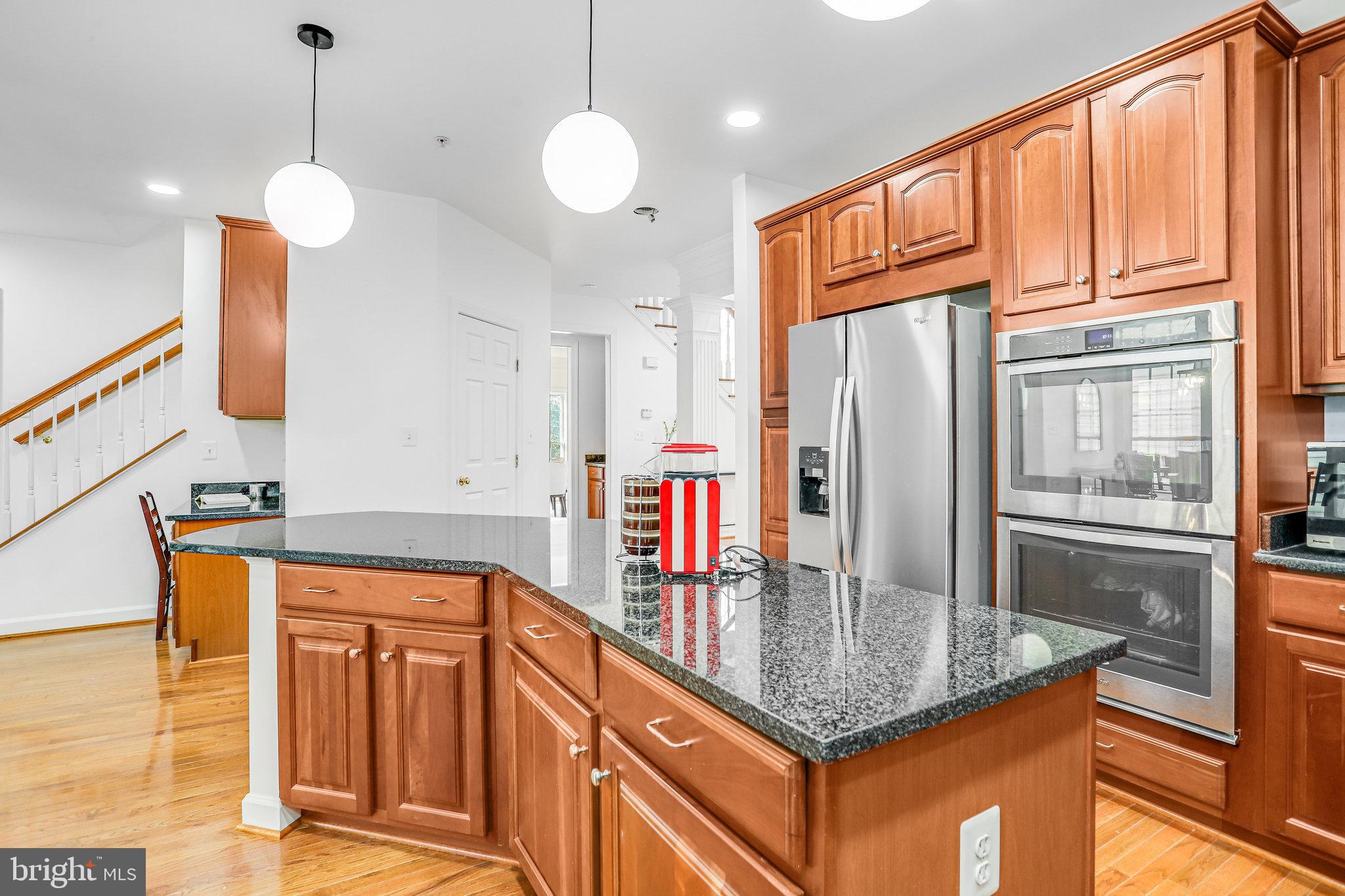 13107 English Turn Drive Silver Spring, MD 20904 - Photo 30 of 73 a kitchen with stainless steel appliances granite countertop a refrigerator a oven and a sink with granite countertops