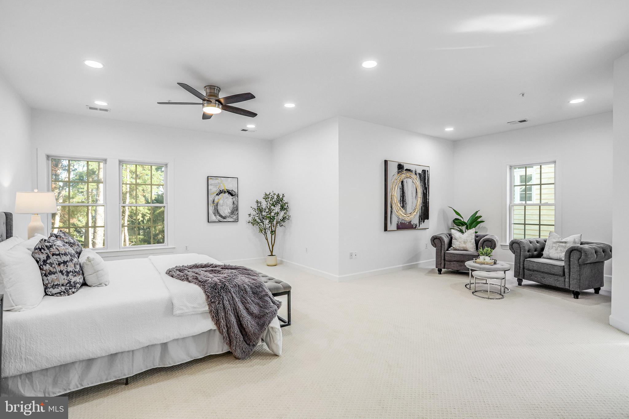 13107 English Turn Drive Silver Spring, MD 20904 - Photo 43 of 73 a spacious bedroom with a bed a couch and a couch