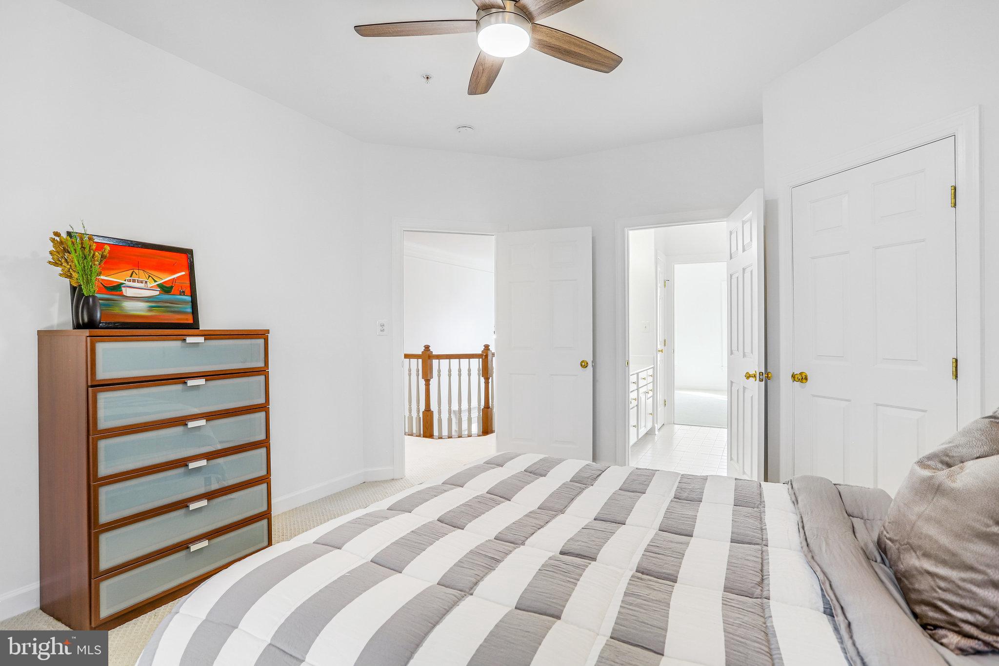 13107 English Turn Drive Silver Spring, MD 20904 - Photo 57 of 73 a bedroom with a bed and a chandelier