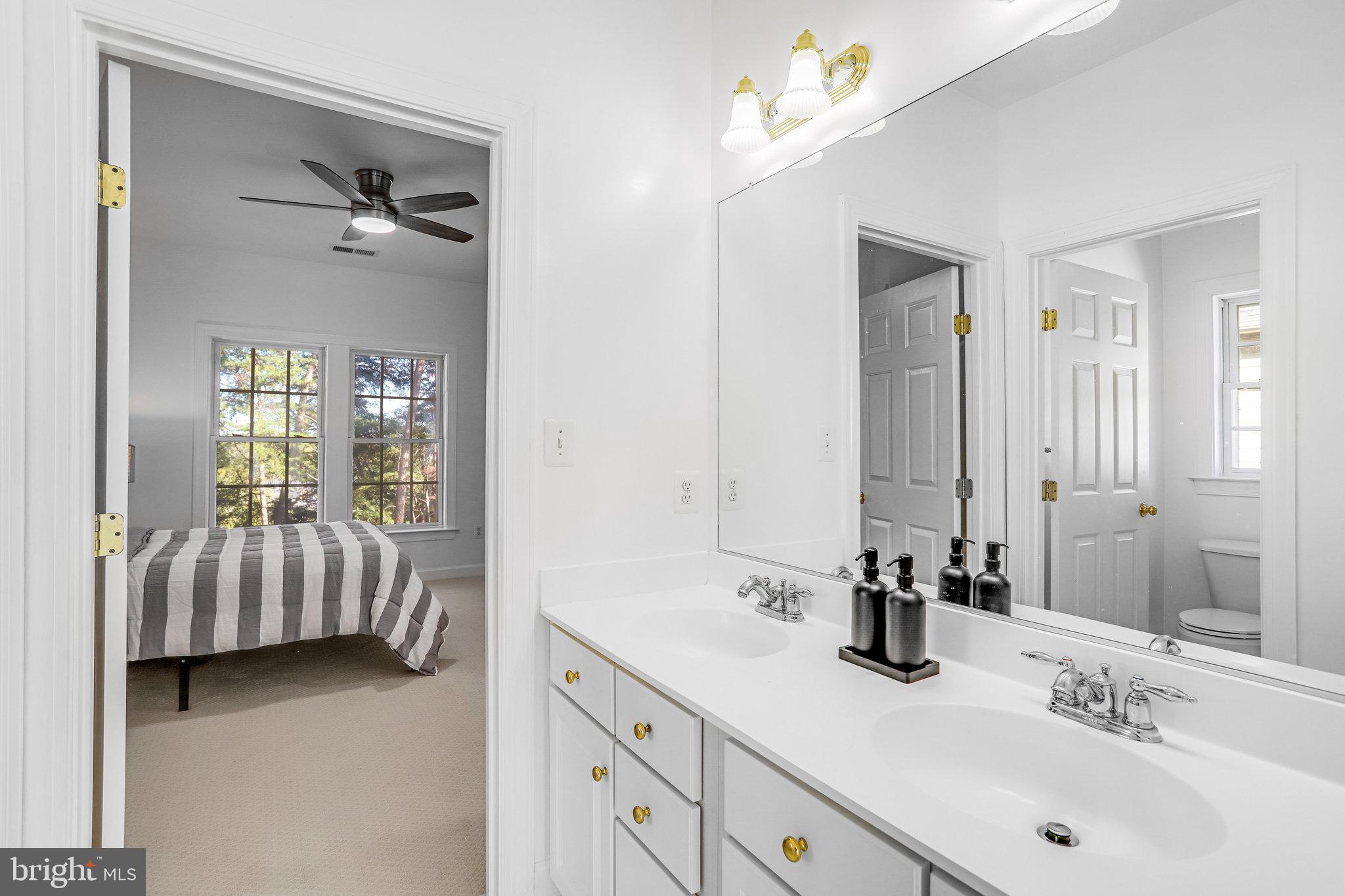 13107 English Turn Drive Silver Spring, MD 20904 - Photo 58 of 73 a en suite bathroom with a double vanity sink tub and mirror