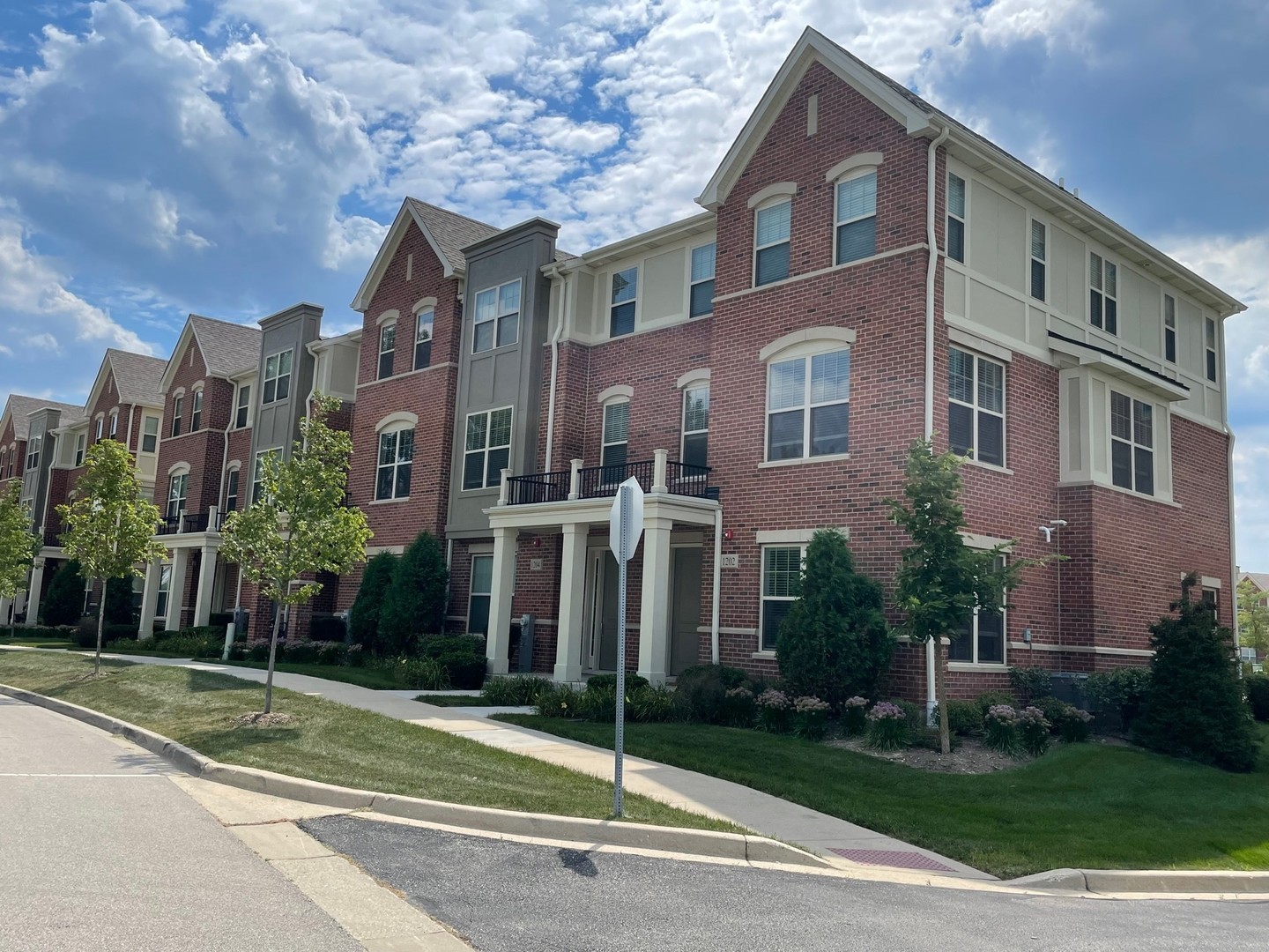 1234 Byrne Boulevard Vernon Hills, IL 60061 - Photo 1 of 12 a view of a brick house next to a yard with big trees