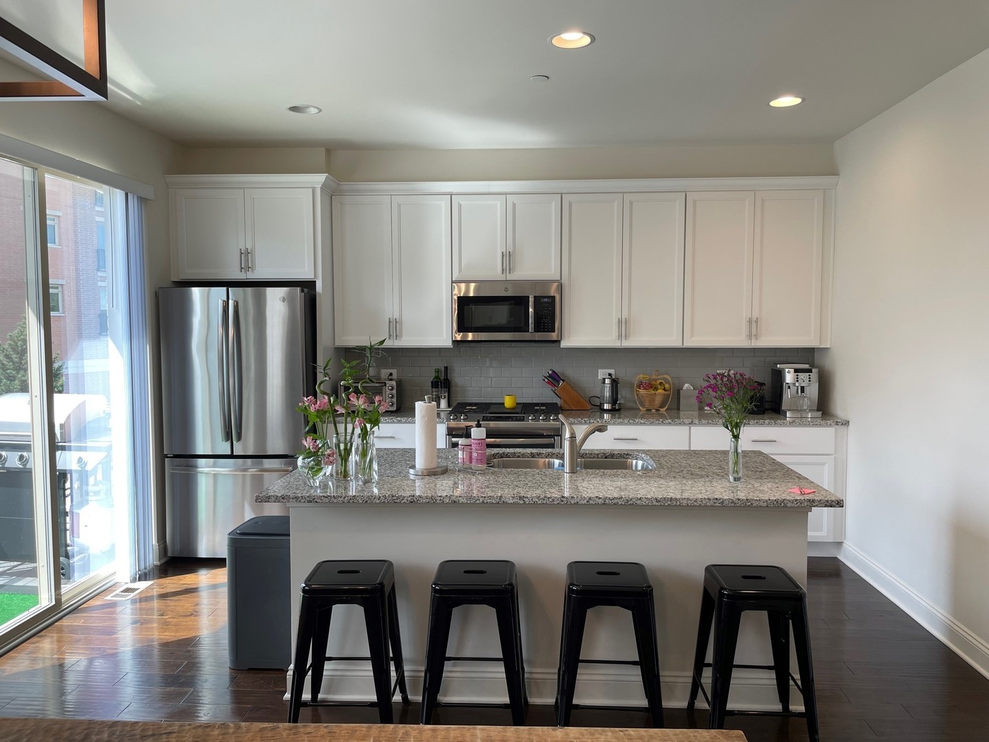 1234 Byrne Boulevard Vernon Hills, IL 60061 - Photo 4 of 12 a kitchen with granite countertop a refrigerator and a stove top oven