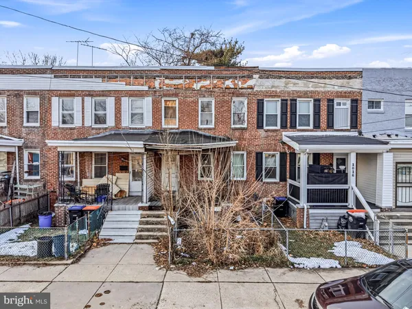 a front view of a building with sitting area