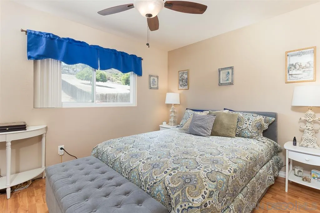 11027 Eddington Road Santee, CA 92071 - Photo 11 of 25 a bedroom with a bed and a night stand