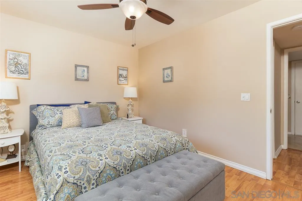 11027 Eddington Road Santee, CA 92071 - Photo 12 of 25 a bedroom with a large bed and a chandelier