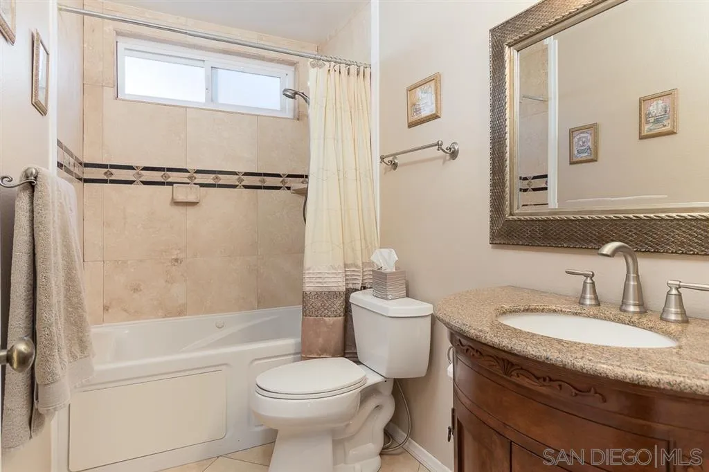 11027 Eddington Road Santee, CA 92071 - Photo 13 of 25 a bathroom with a granite countertop sink toilet and shower