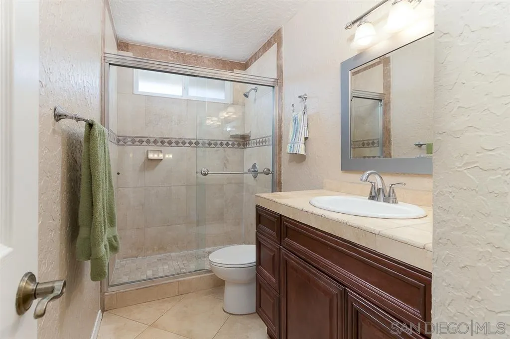 11027 Eddington Road Santee, CA 92071 - Photo 20 of 25 a bathroom with a sink a toilet and shower