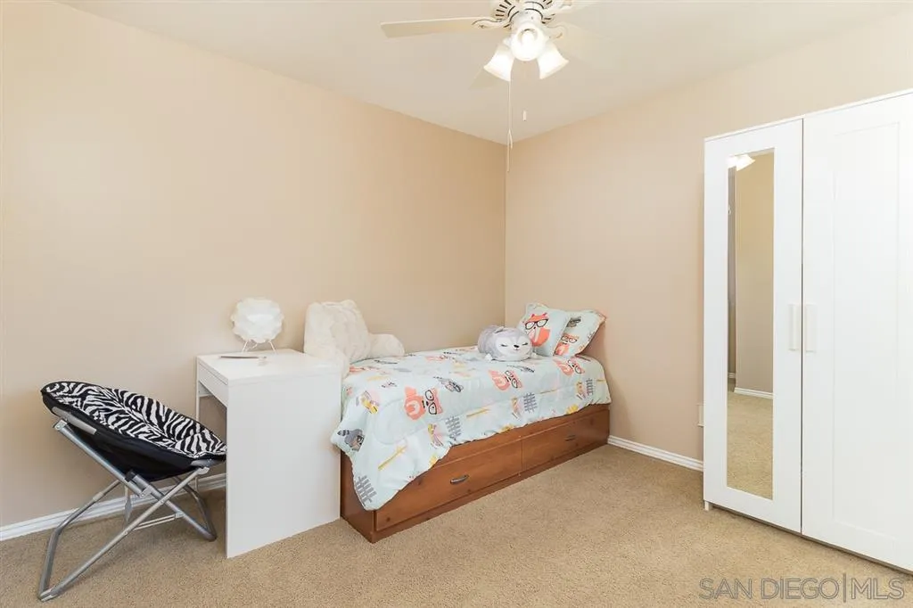 11027 Eddington Road Santee, CA 92071 - Photo 21 of 25 a bedroom with a bed and a chandelier