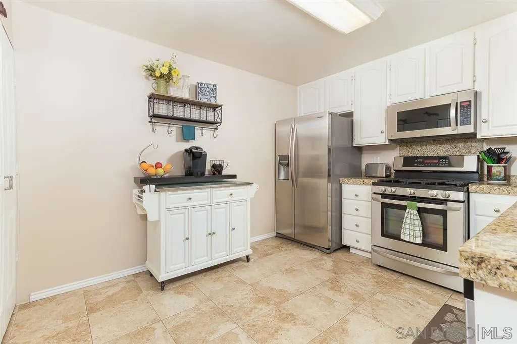 11027 Eddington Road Santee, CA 92071 - Photo 6 of 25 a kitchen with stainless steel appliances a refrigerator stove and microwave