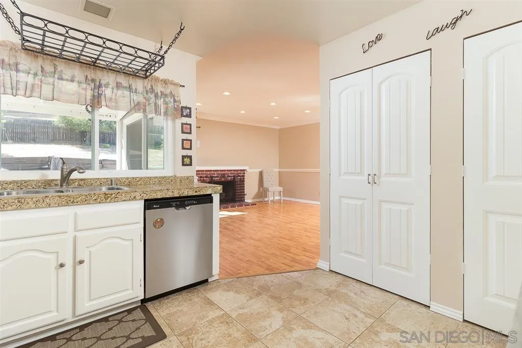 11027 Eddington Road Santee, CA 92071 - Photo 8 of 25 a kitchen with granite countertop white cabinets and white appliances