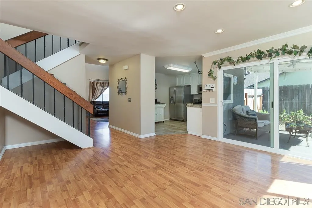 11027 Eddington Road Santee, CA 92071 - Photo 10 of 25 a view of a hallway with wooden floor and staircase