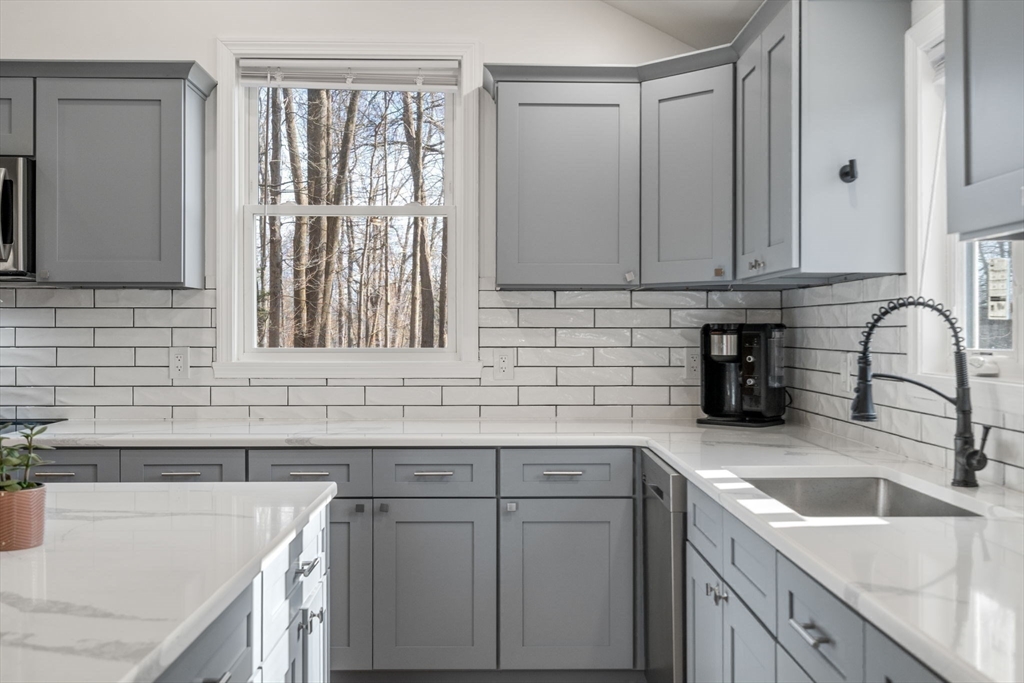 146 Warren Road Brimfield, MA 01010 - Photo 5 of 30 a kitchen with granite countertop a sink dishwasher a stove and cabinets