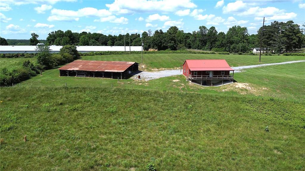 765 Addison Road Buchanan, GA 30113 - Photo 33 of 50 a view of backyard of a house with outdoor seating and green space