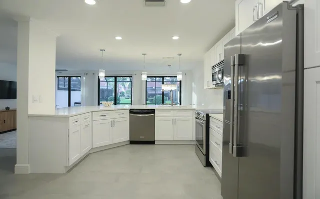 a large bathroom with a large mirror vanity and shower