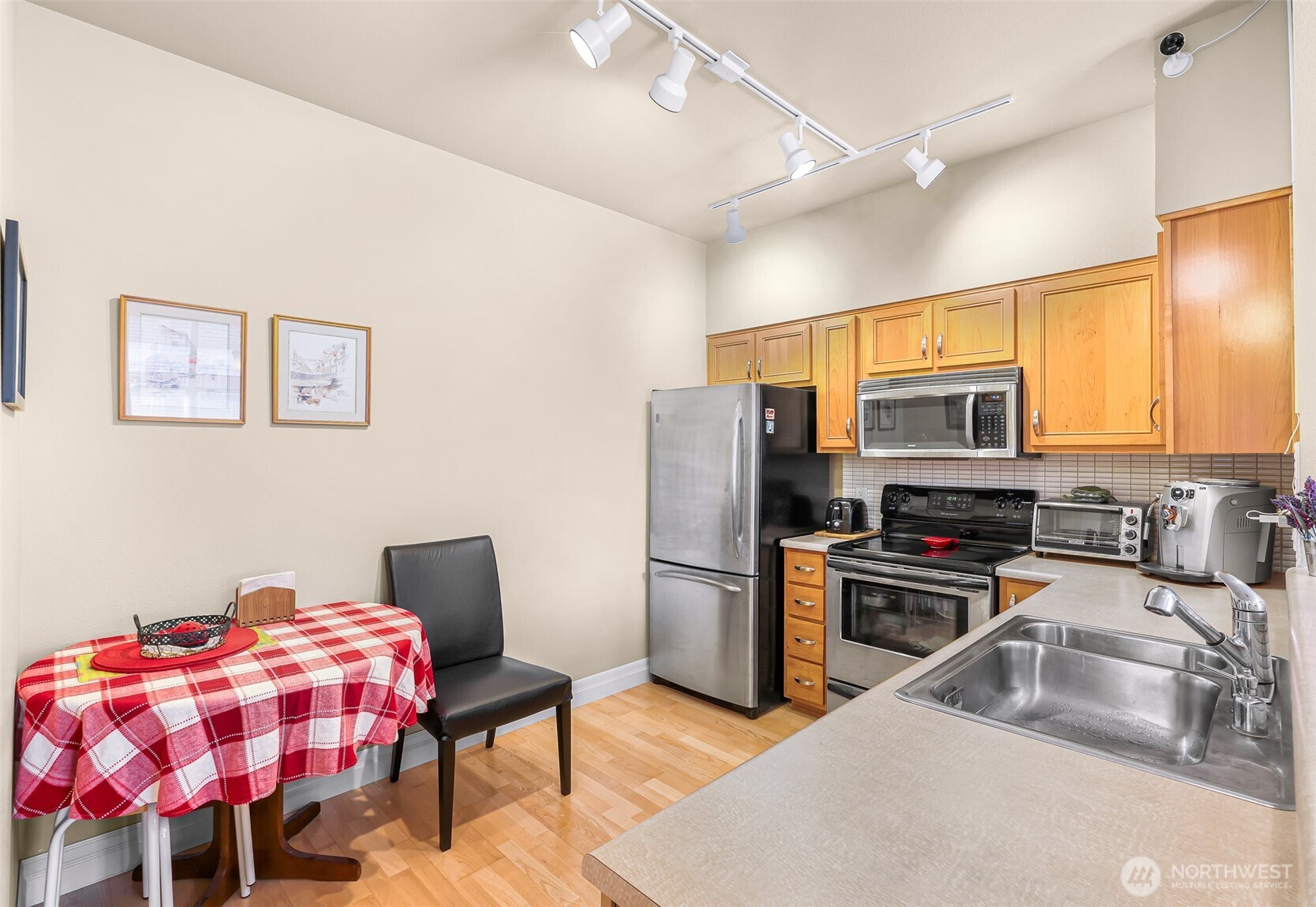 910 Harris Avenue, Unit 208 Bellingham, WA 98225 - Photo 11 of 33 a kitchen with stainless steel appliances granite countertop a sink refrigerator and microwave