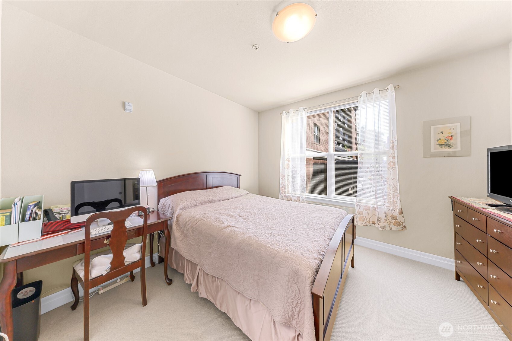 910 Harris Avenue, Unit 208 Bellingham, WA 98225 - Photo 24 of 33 a bedroom with a bed and a flat tv screen on the dresser