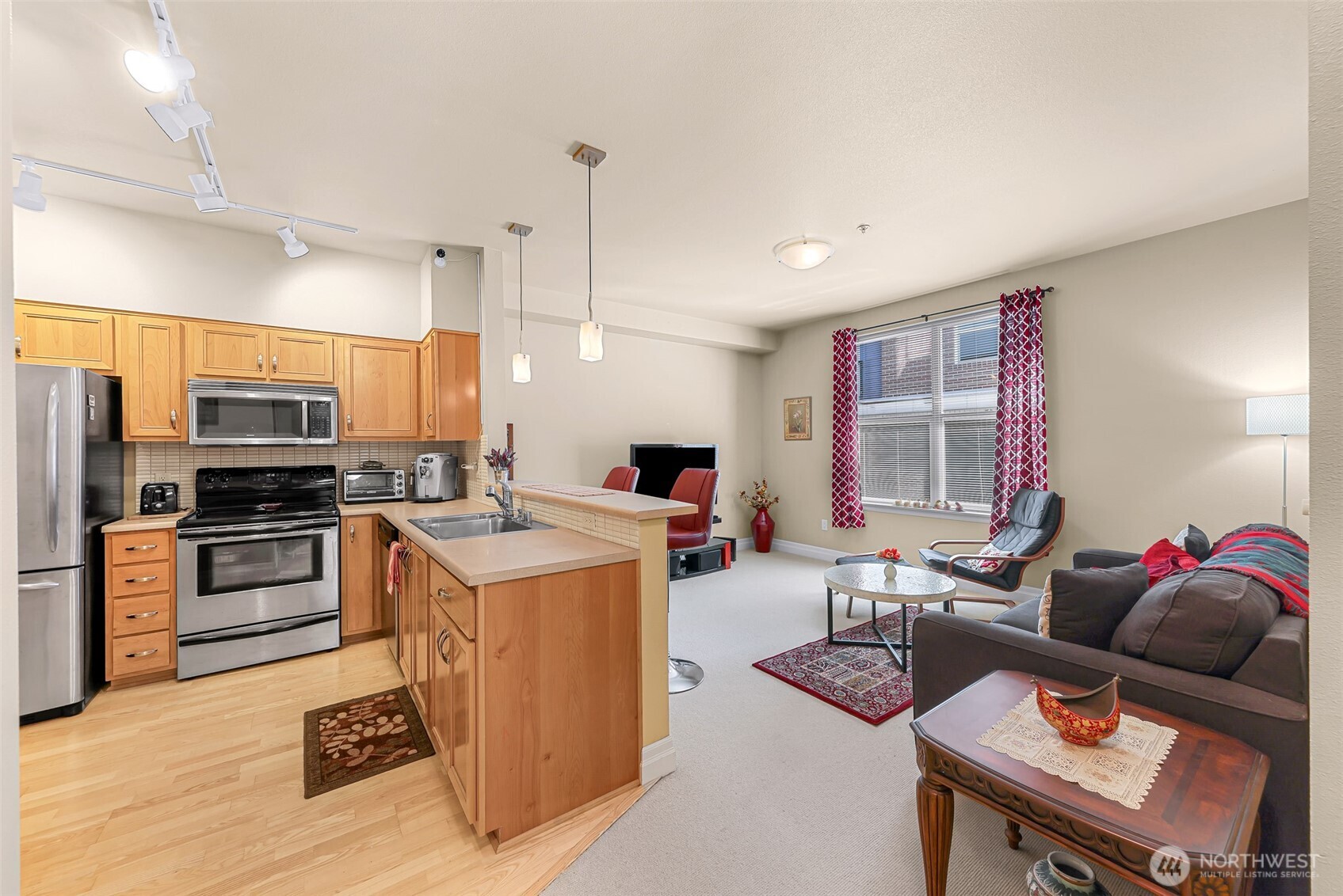 910 Harris Avenue, Unit 208 Bellingham, WA 98225 - Photo 8 of 33 a living room with furniture a flat screen tv and kitchen view