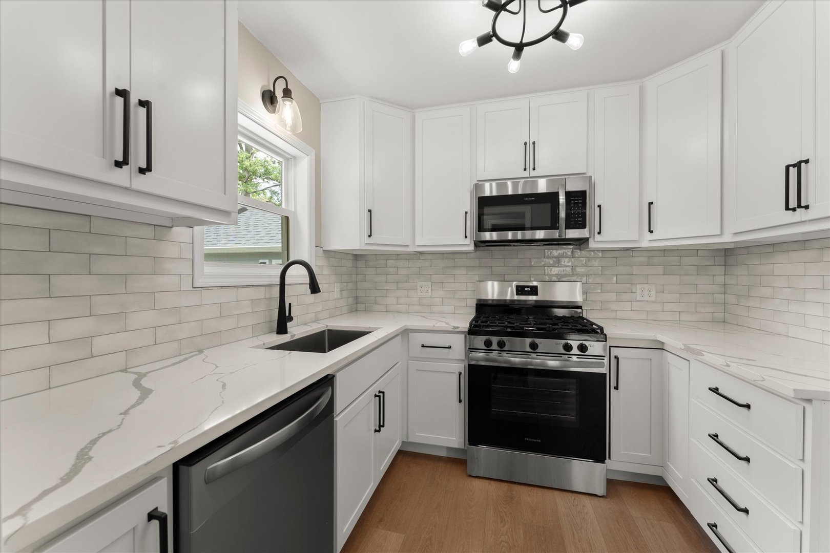 305 South Fair Street Champaign, IL 61821 - Photo 14 of 41 a kitchen with cabinets stainless steel appliances a sink and a stove