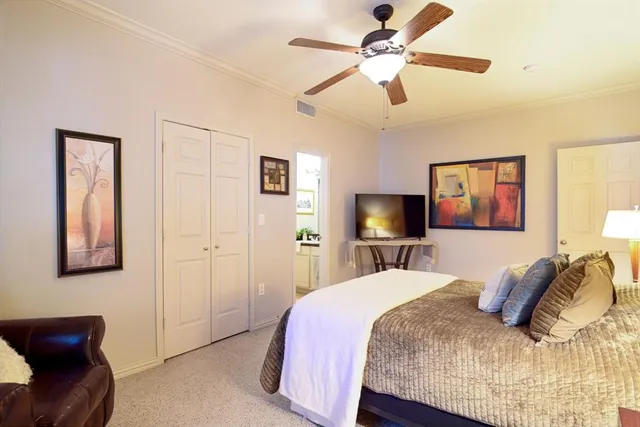 a bedroom with a large bed and a chandelier