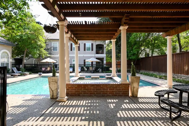 a view of a patio with table and chairs potted plants and a large tree