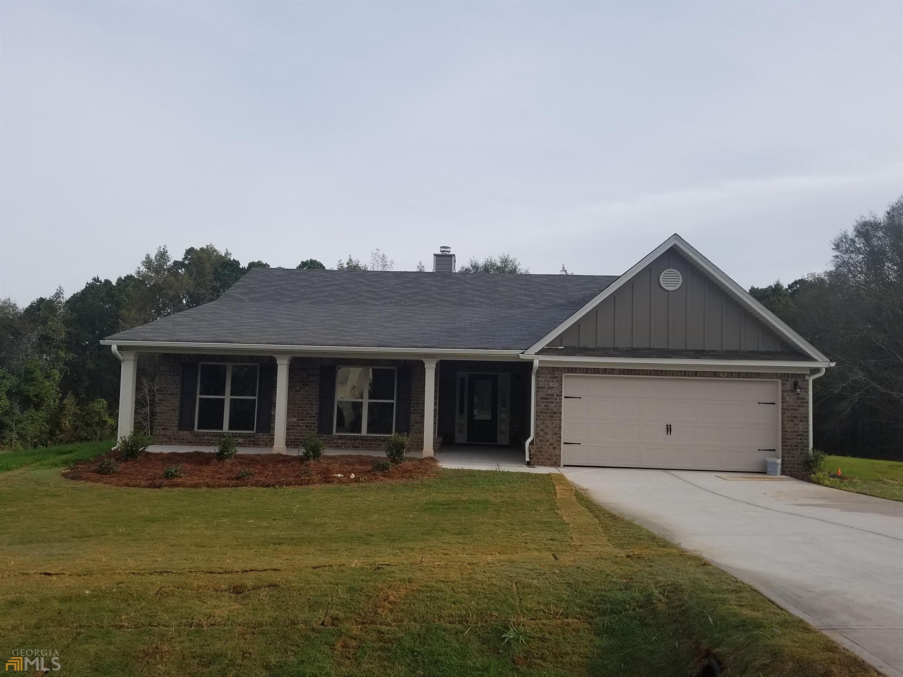 2046 Providence Road, Unit 8 Statham, GA 30666 - Photo 1 of 1 a house with trees in front of it