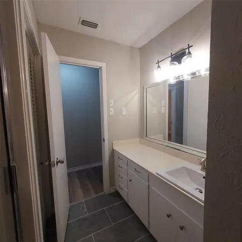 a bathroom with a double vanity sink and a mirror