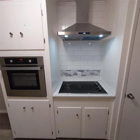 a close view of a stove and utility room with a sink
