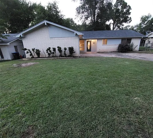 a front view of house with yard outdoor seating and green space