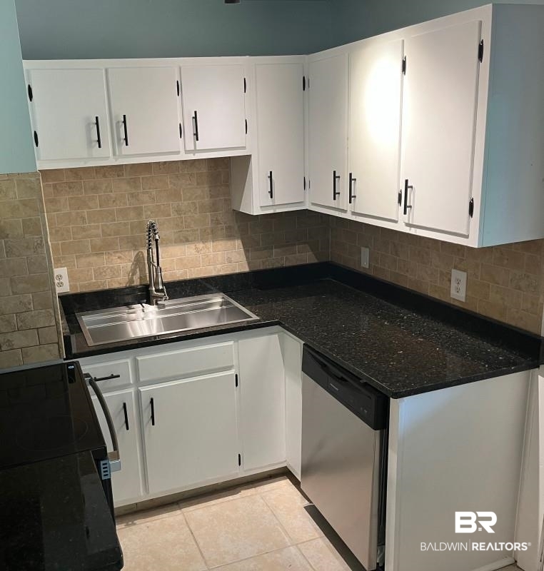609 East Orange Avenue Foley, AL 36535 - Photo 2 of 6 Kitchen featuring black electric range oven, white cabinetry, stainless steel dishwasher, and decorative backsplash