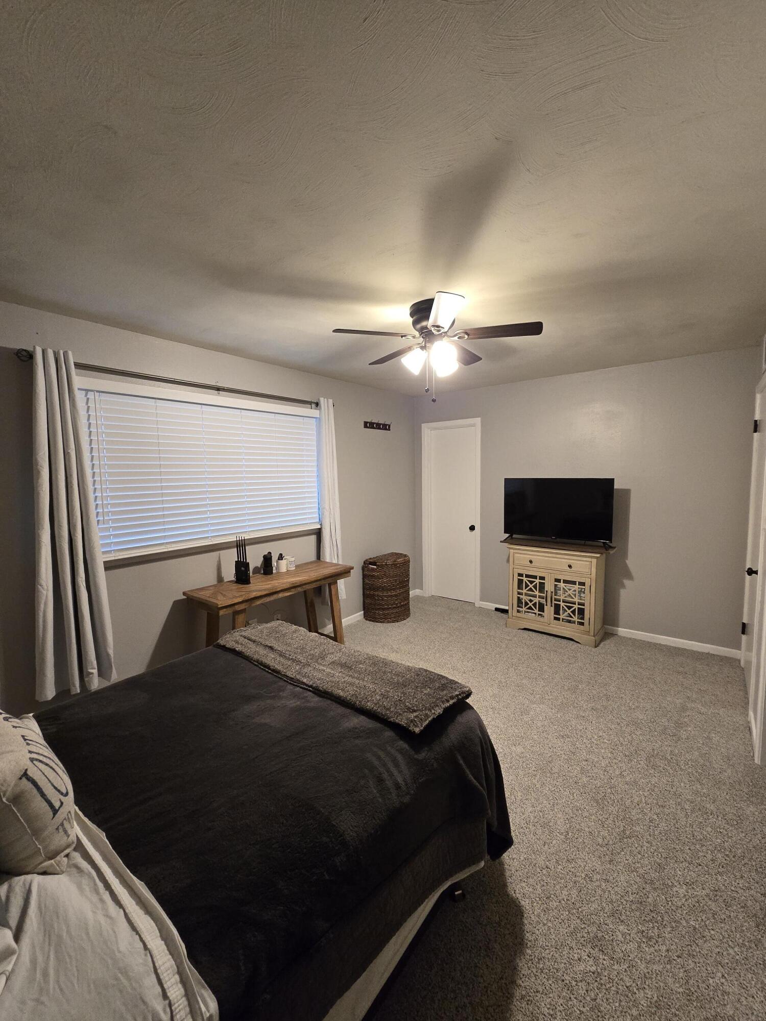 305 North 21st Street Lamesa, TX 79331 - Photo 15 of 23 a bedroom with a bed and a flat screen tv