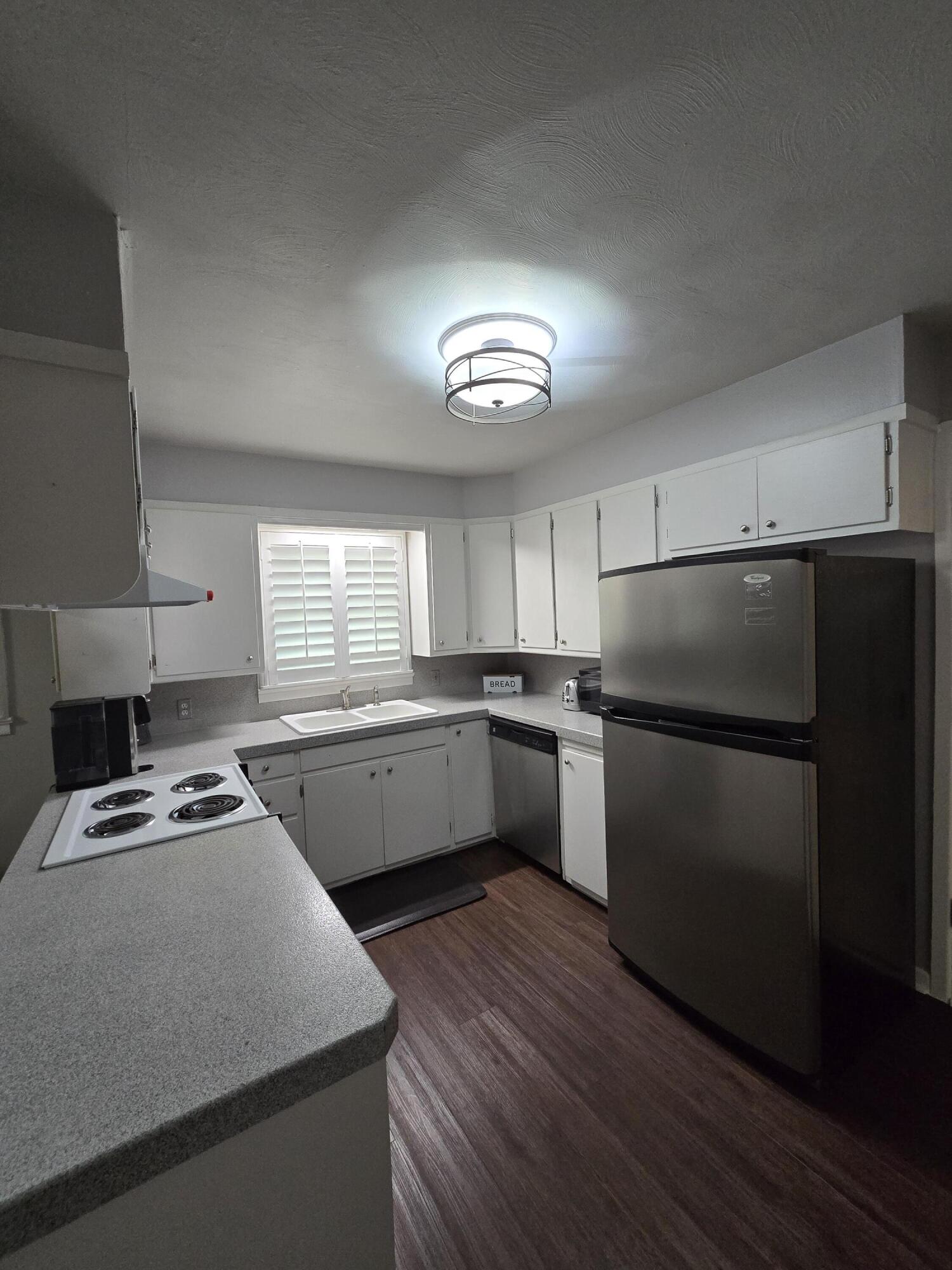 305 North 21st Street Lamesa, TX 79331 - Photo 4 of 23 a kitchen with a refrigerator and a stove top oven