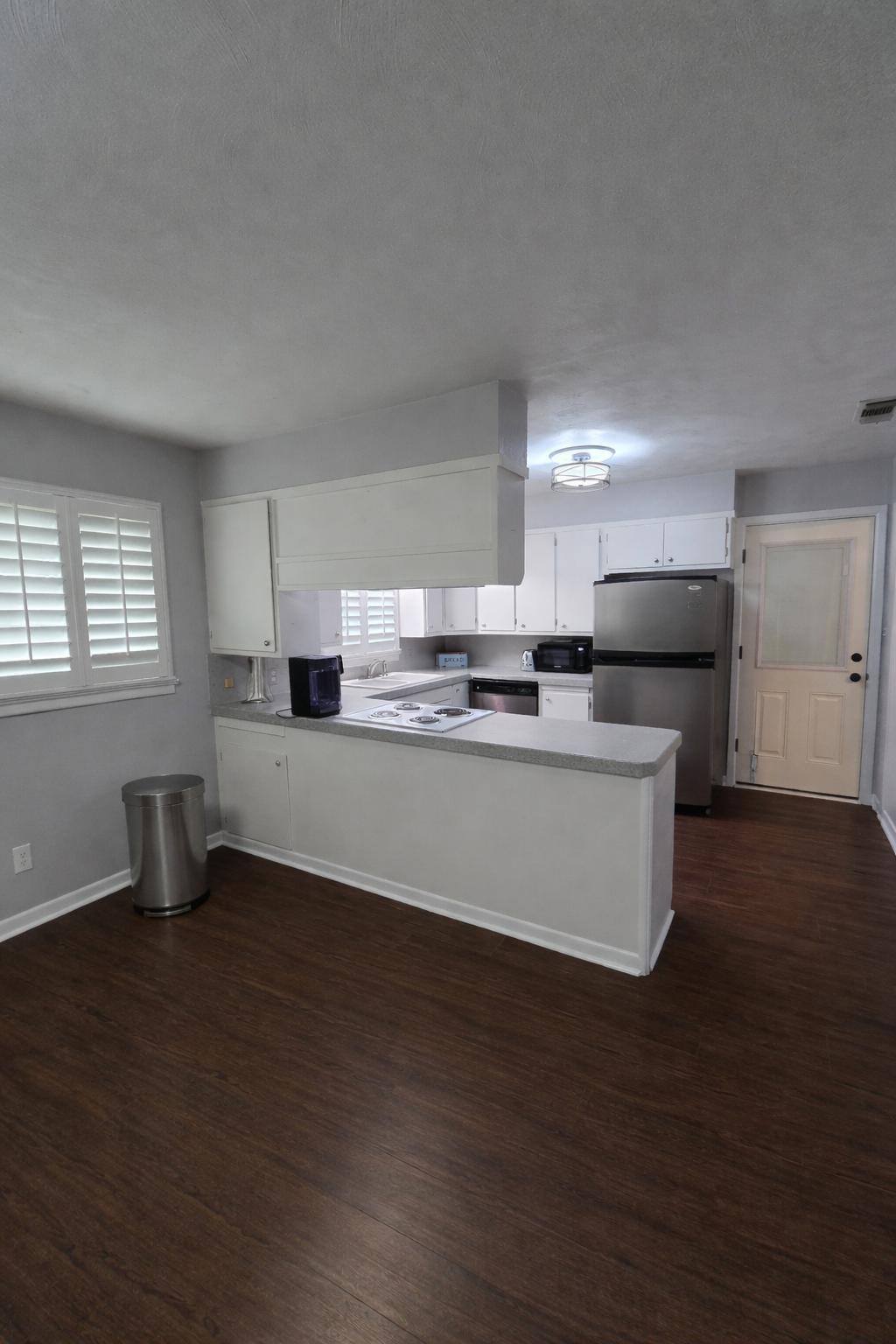 305 North 21st Street Lamesa, TX 79331 - Photo 8 of 23 a large kitchen with stainless steel appliances granite countertop a stove a sink a refrigerator and white cabinets