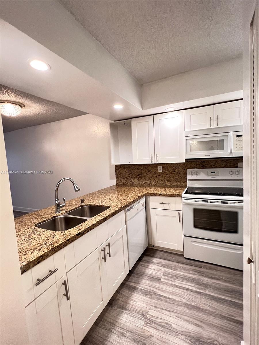 6800 Cypress Road, Unit 211 Plantation, FL 33317 - Photo 1 of 19 a kitchen with granite countertop a sink and cabinets