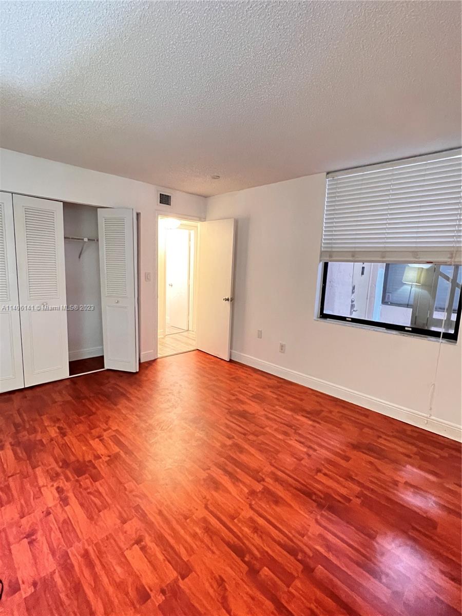 6800 Cypress Road, Unit 211 Plantation, FL 33317 - Photo 11 of 19 a view of an empty room with wooden floor and closet