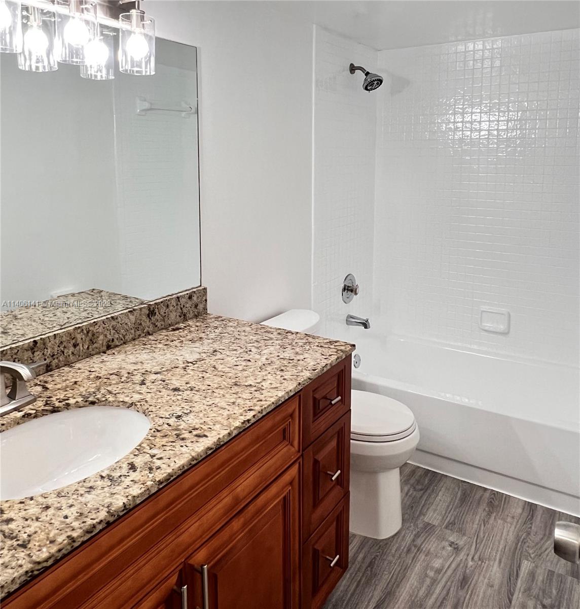 6800 Cypress Road, Unit 211 Plantation, FL 33317 - Photo 12 of 19 a bathroom with a granite countertop sink a toilet and shower
