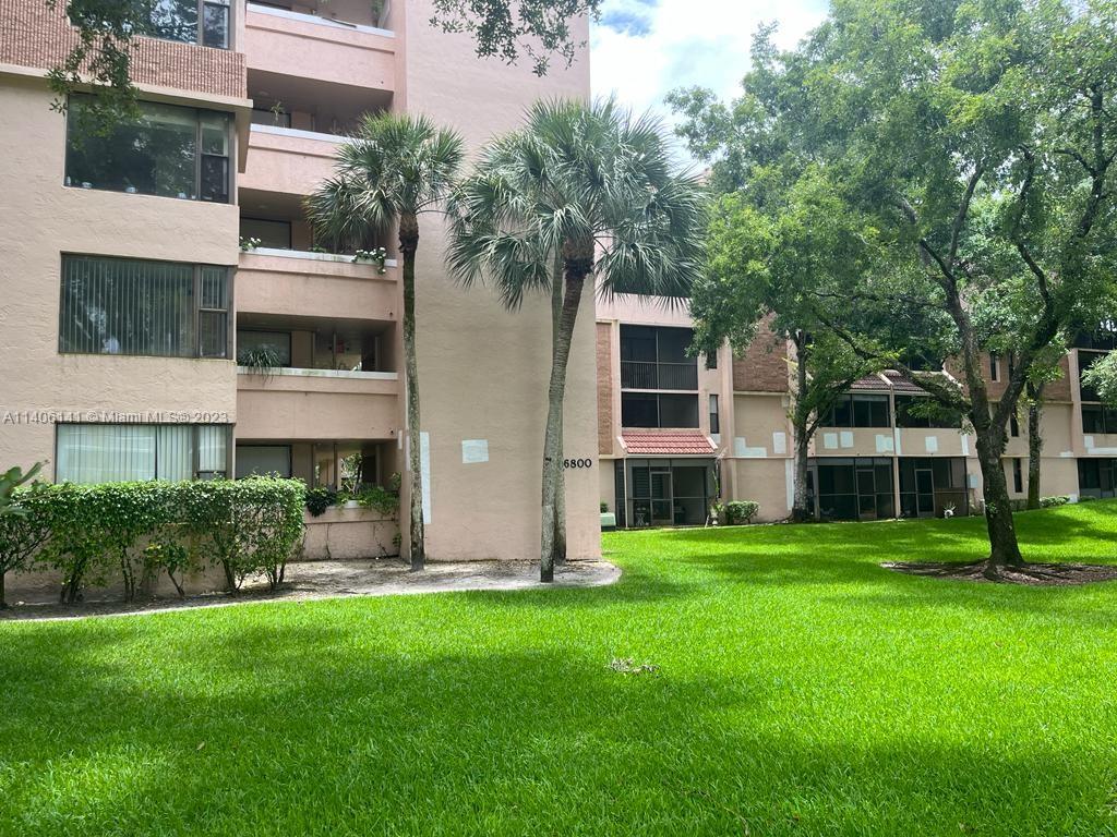 6800 Cypress Road, Unit 211 Plantation, FL 33317 - Photo 16 of 19 a front view of building with yard